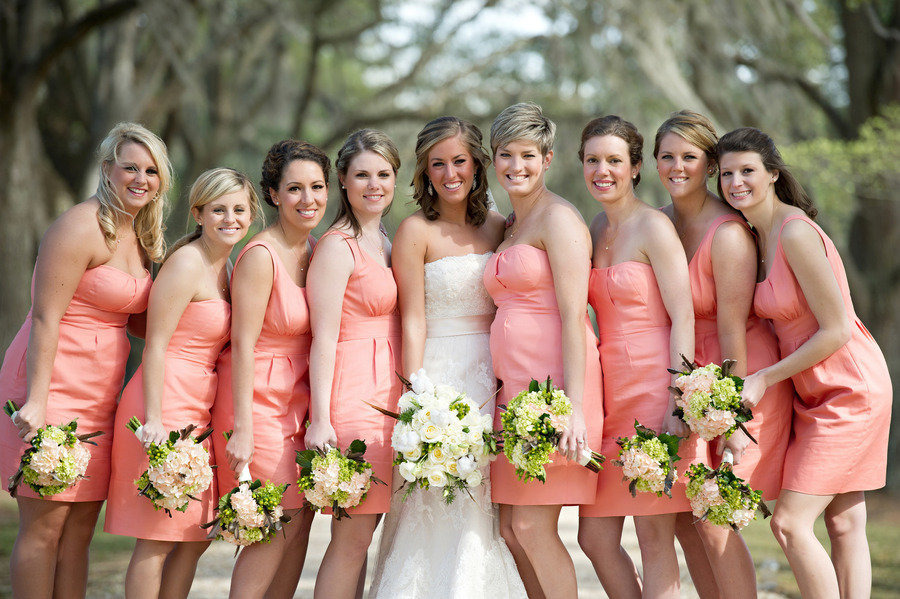bride with bridesmaids in peach colored dresses