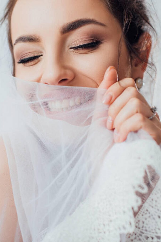 bride covers her face with veil