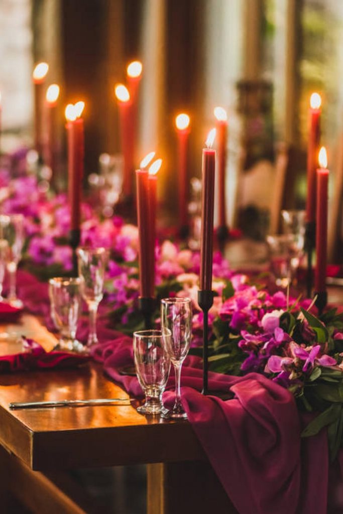 dark red table setting with candles